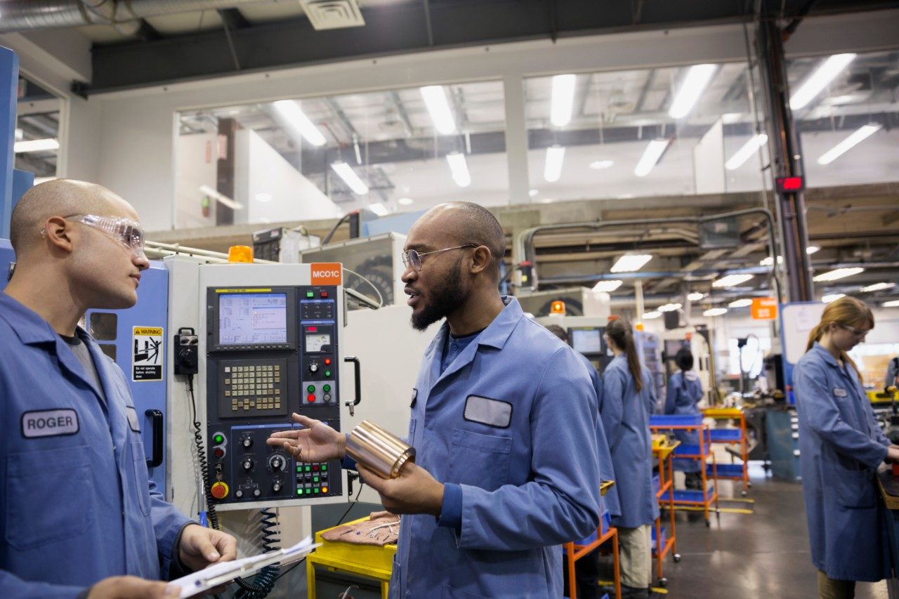 diverse men working in manufacturing facility